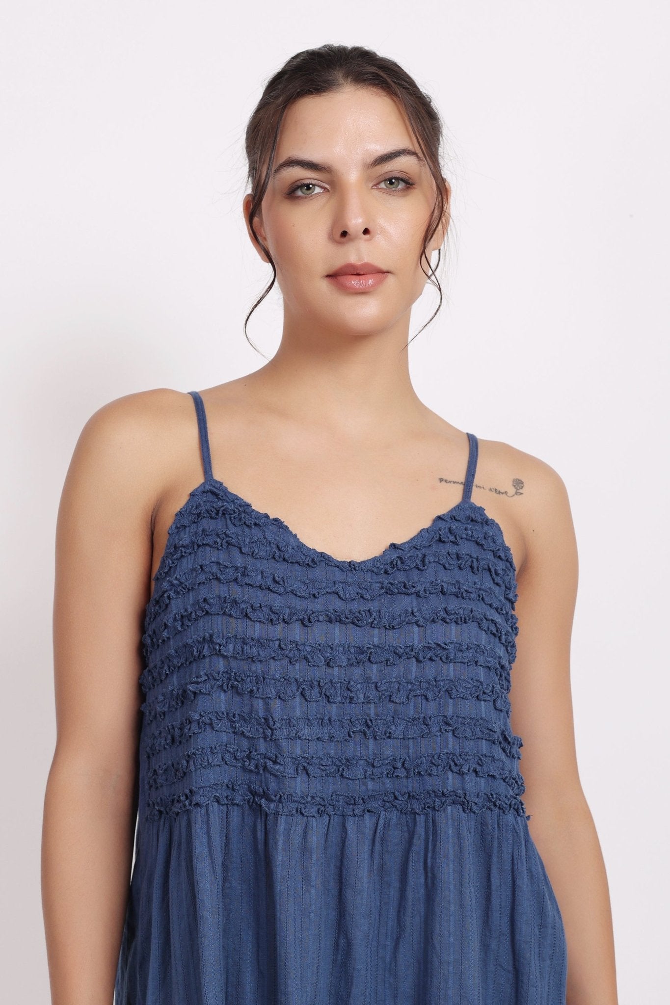 Detail of crochet frill neckline and pin tuck finish on navy self-stripe cotton.