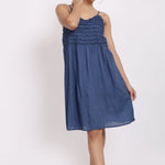 Model wearing navy self-stripe cotton nightie with frill detail and spaghetti straps.