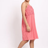 Angled side profile of coral cotton nightie highlighting light drape and relaxed fit.