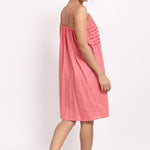 Back view of spaghetti strap nightie in coral cotton voile with self-stripe detail.