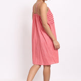 Back view of spaghetti strap nightie in coral cotton voile with self-stripe detail.