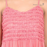 Close-up of chest frill trim and stripe texture on coral cotton nightdress.