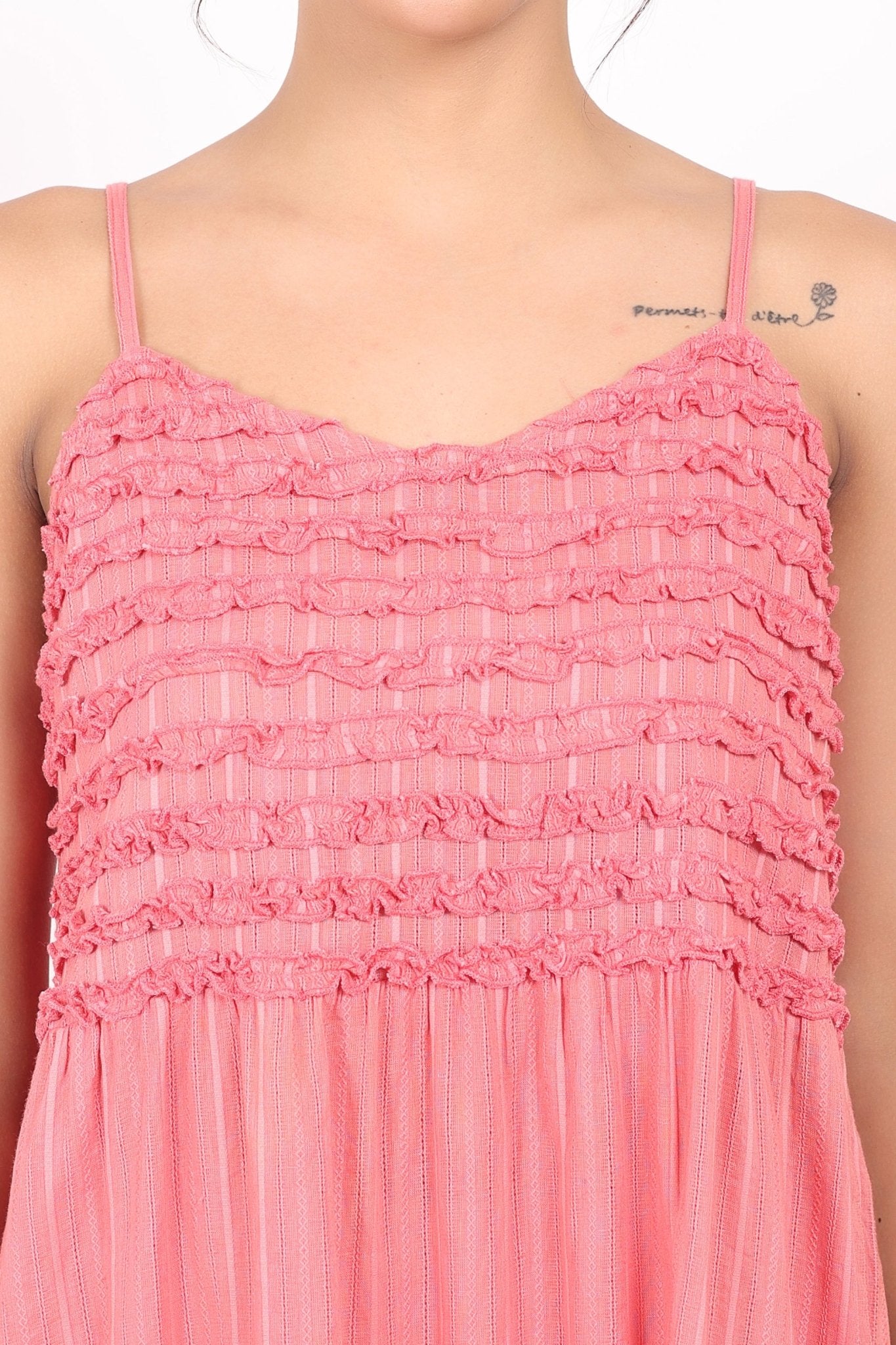 Close-up of chest frill trim and stripe texture on coral cotton nightdress.
