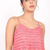 Portrait of model showing shoulder straps and upper bodice of coral cotton nightie.