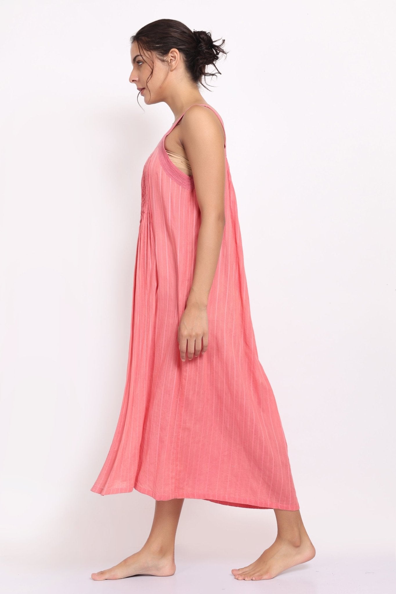 Side view of coral summer sleepdress with flowing hem and lightweight texture.