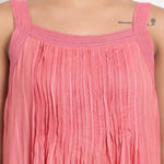 Detail of square neckline with soft crochet straps on coral striped cotton.