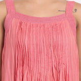 Detail of square neckline with soft crochet straps on coral striped cotton.