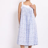 Front view of Model wearing white cotton nightie with navy floral print, crochet straps, and pintuck pleats.