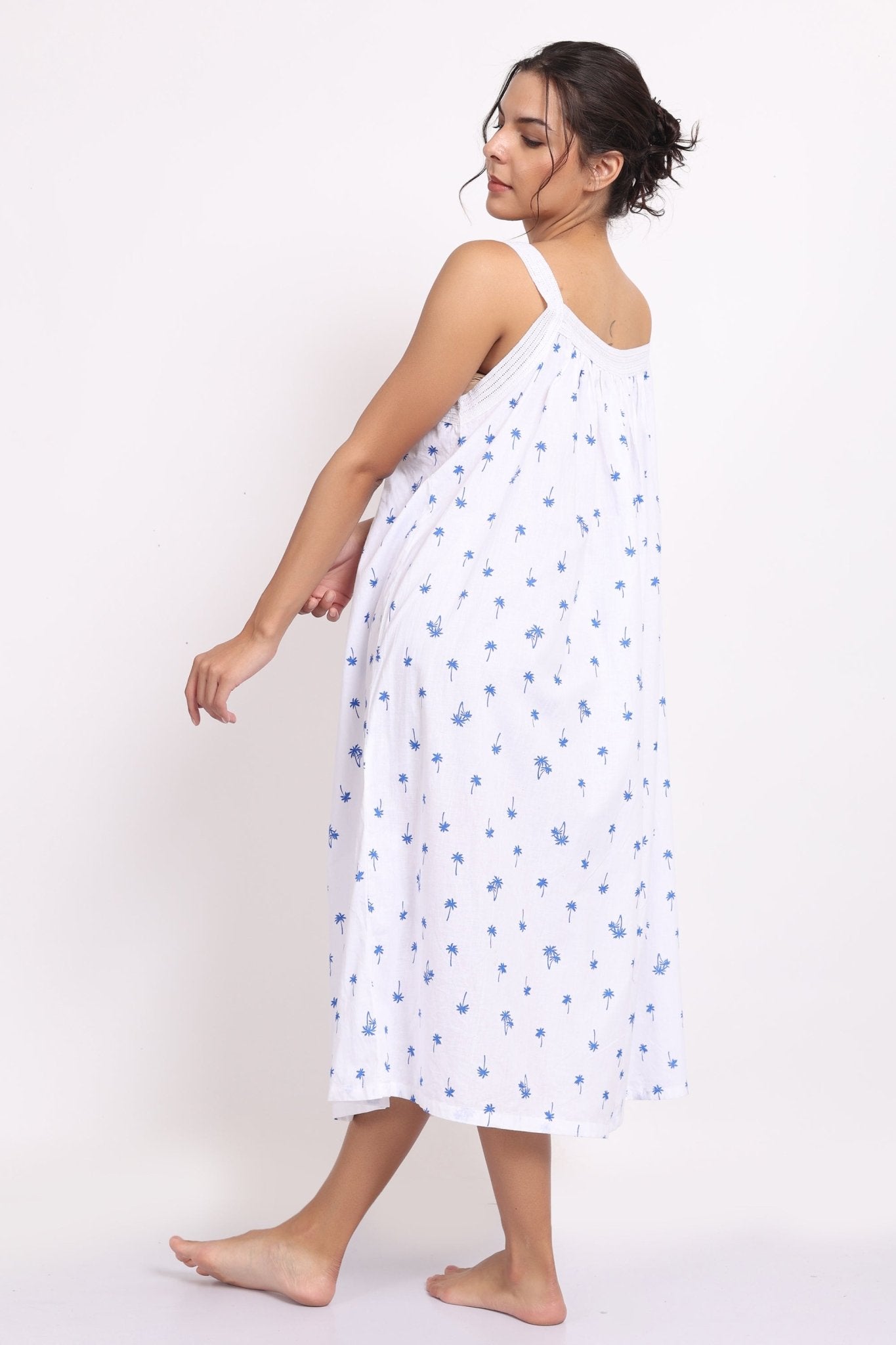 Playful twirl showcasing the lightness and movement of the navy palm print strappy nightie Back view.