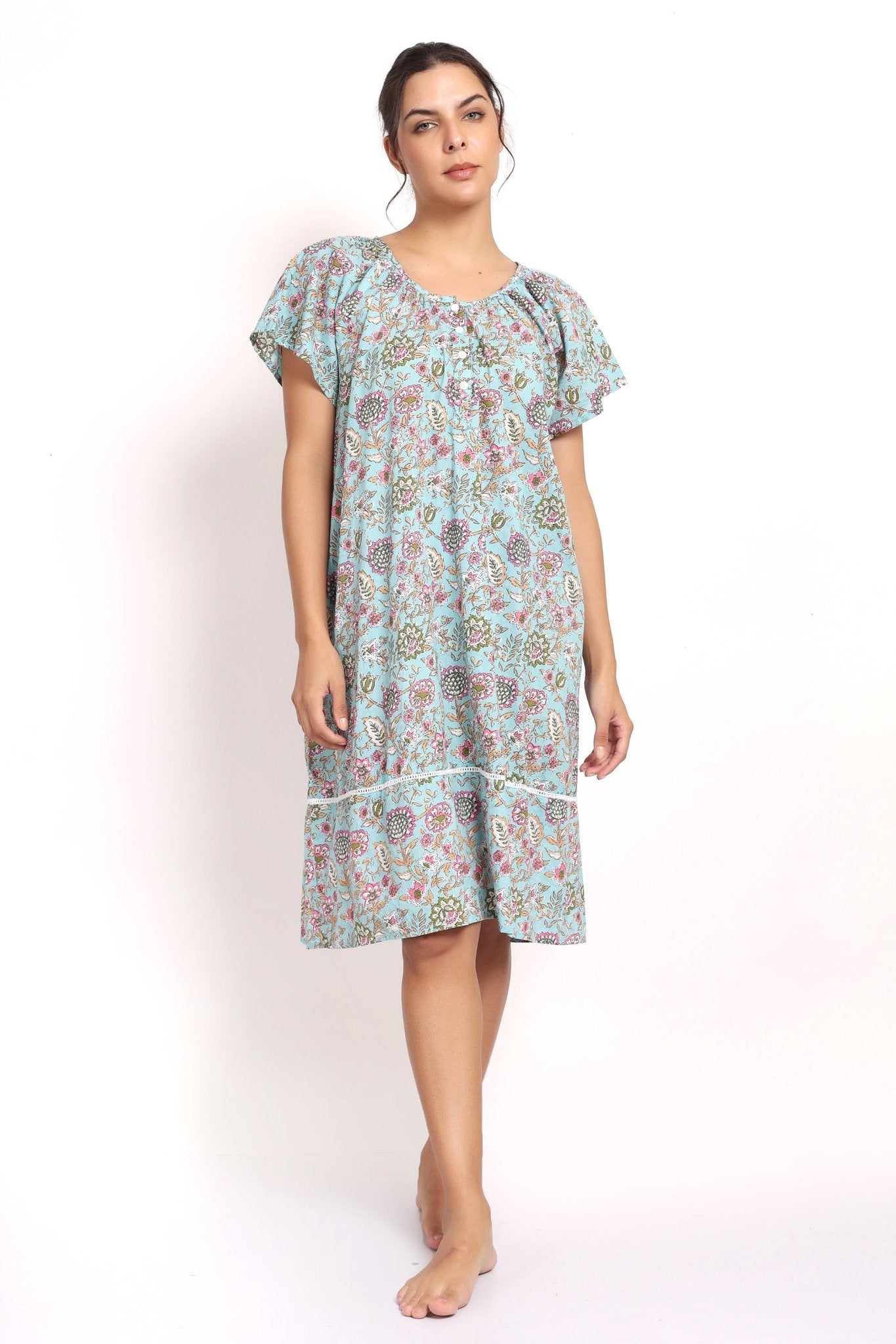Front view Model wearing aqua floral cotton nightie with cap sleeves and mid-length hem.