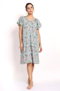 Front view Model wearing aqua floral cotton nightie with cap sleeves and mid-length hem.