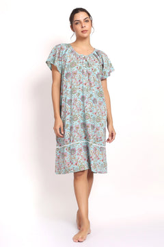 Front view Model wearing aqua floral cotton nightie with cap sleeves and mid-length hem.