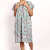 Front view of model in lightweight floral nightie with buttoned neckline and flutter sleeves.