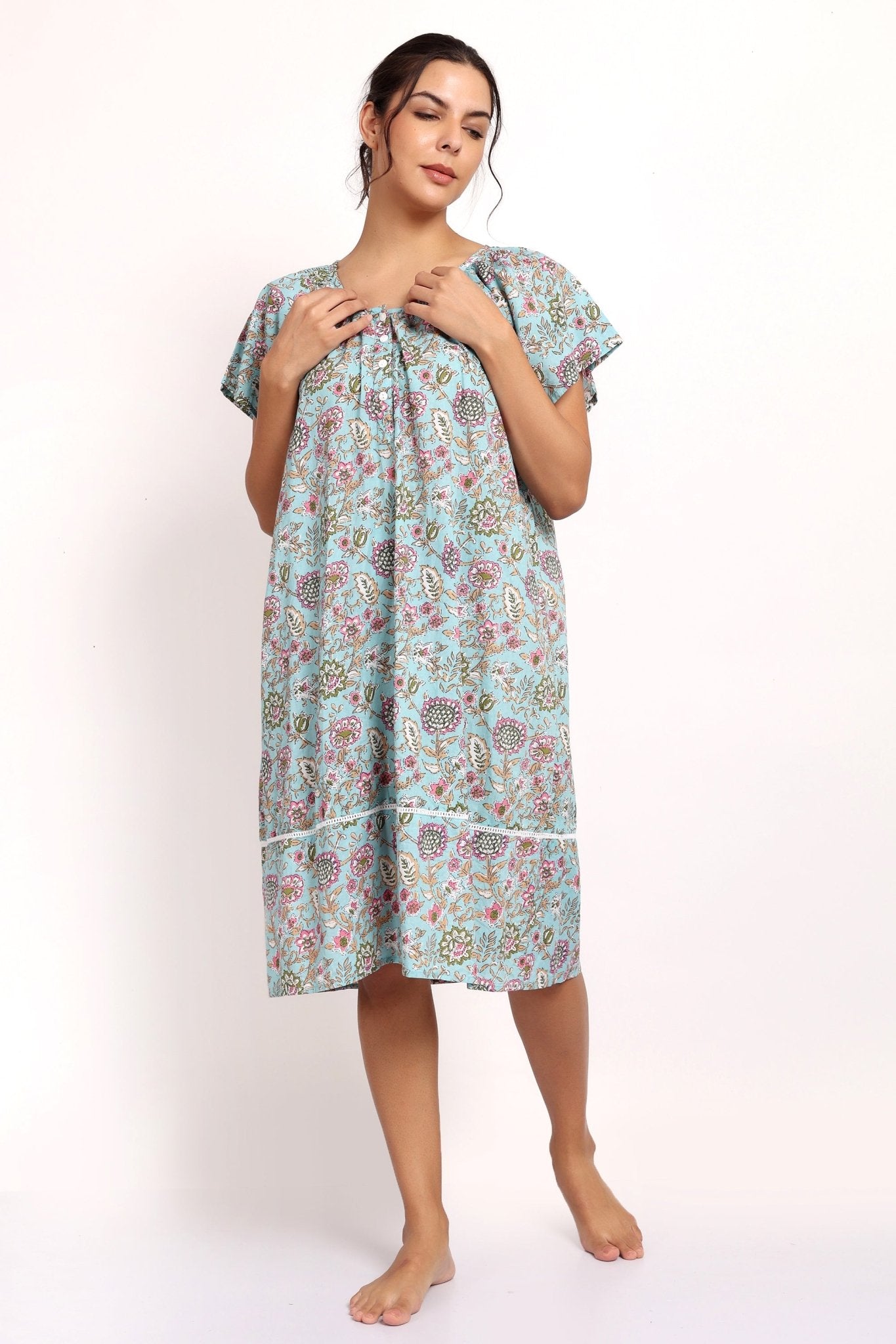 Front view of model in lightweight floral nightie with buttoned neckline and flutter sleeves.