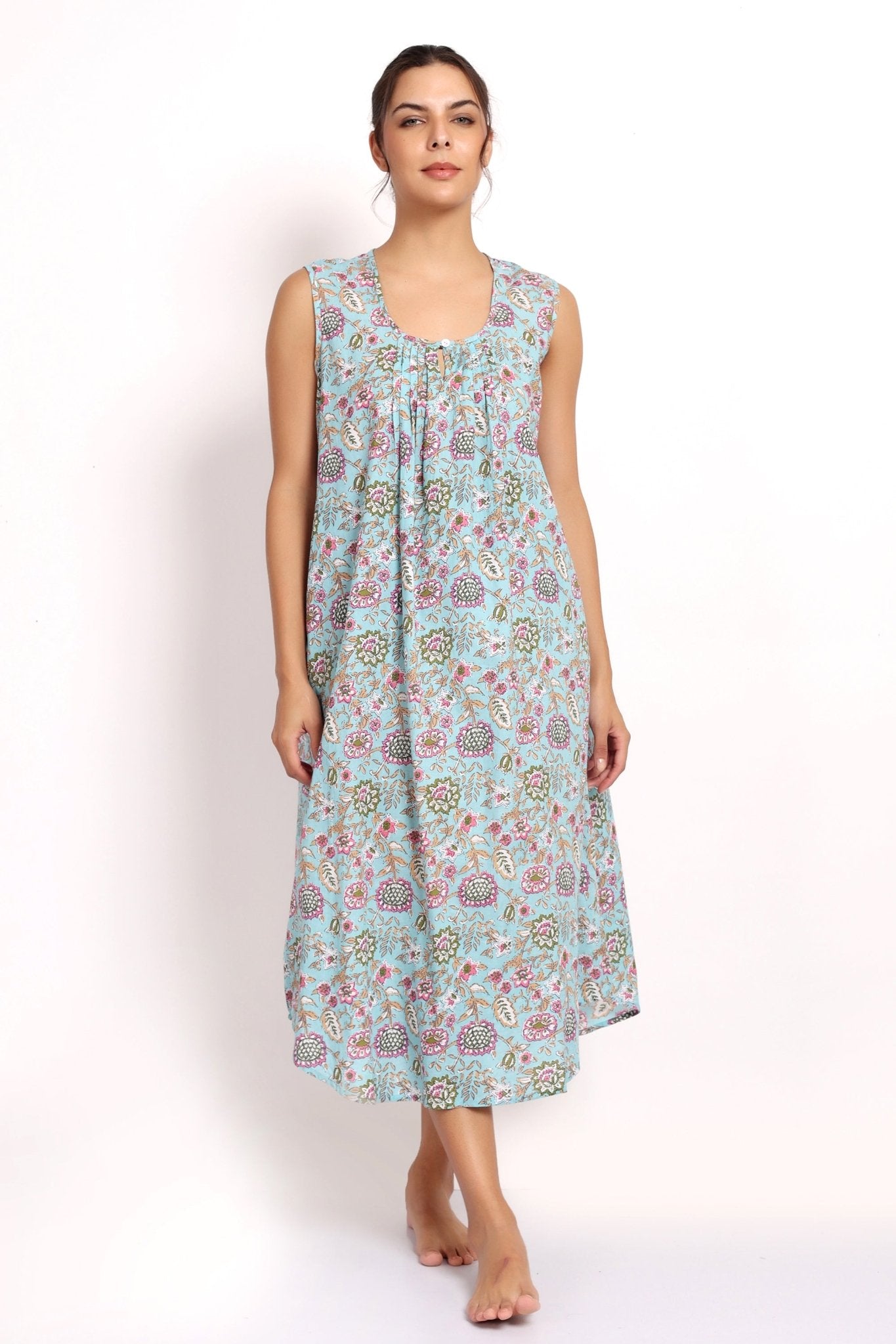 Model wearing Bloom Sleeveless Nightie in aqua floral print, mid-calf length with scooped hem and gathered neckline.