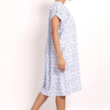 Model turned slightly, showing side seam and airy cotton fabric. Side view