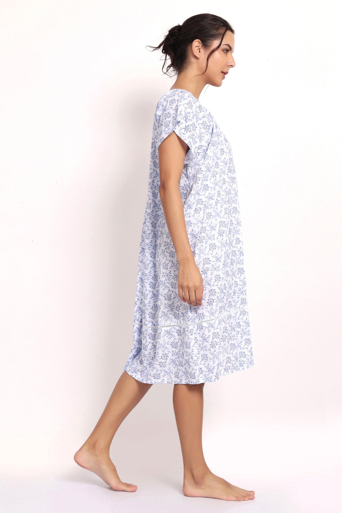 Model turned slightly, showing side seam and airy cotton fabric. Side view
