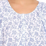 Detail view of round neckline with soft pleating and floral pattern.