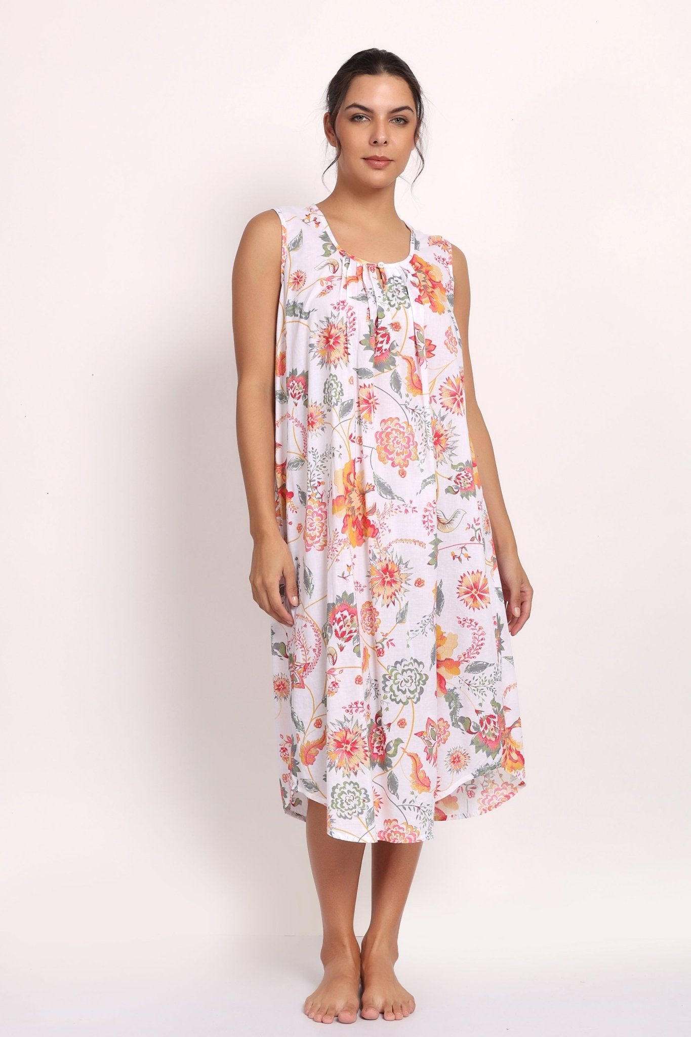 Model wearing sleeveless coral print nightie with gathered neckline and relaxed fit.