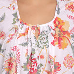 Detailed view of the softly gathered neckline with single button front.