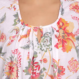 Detailed view of the softly gathered neckline with single button front.