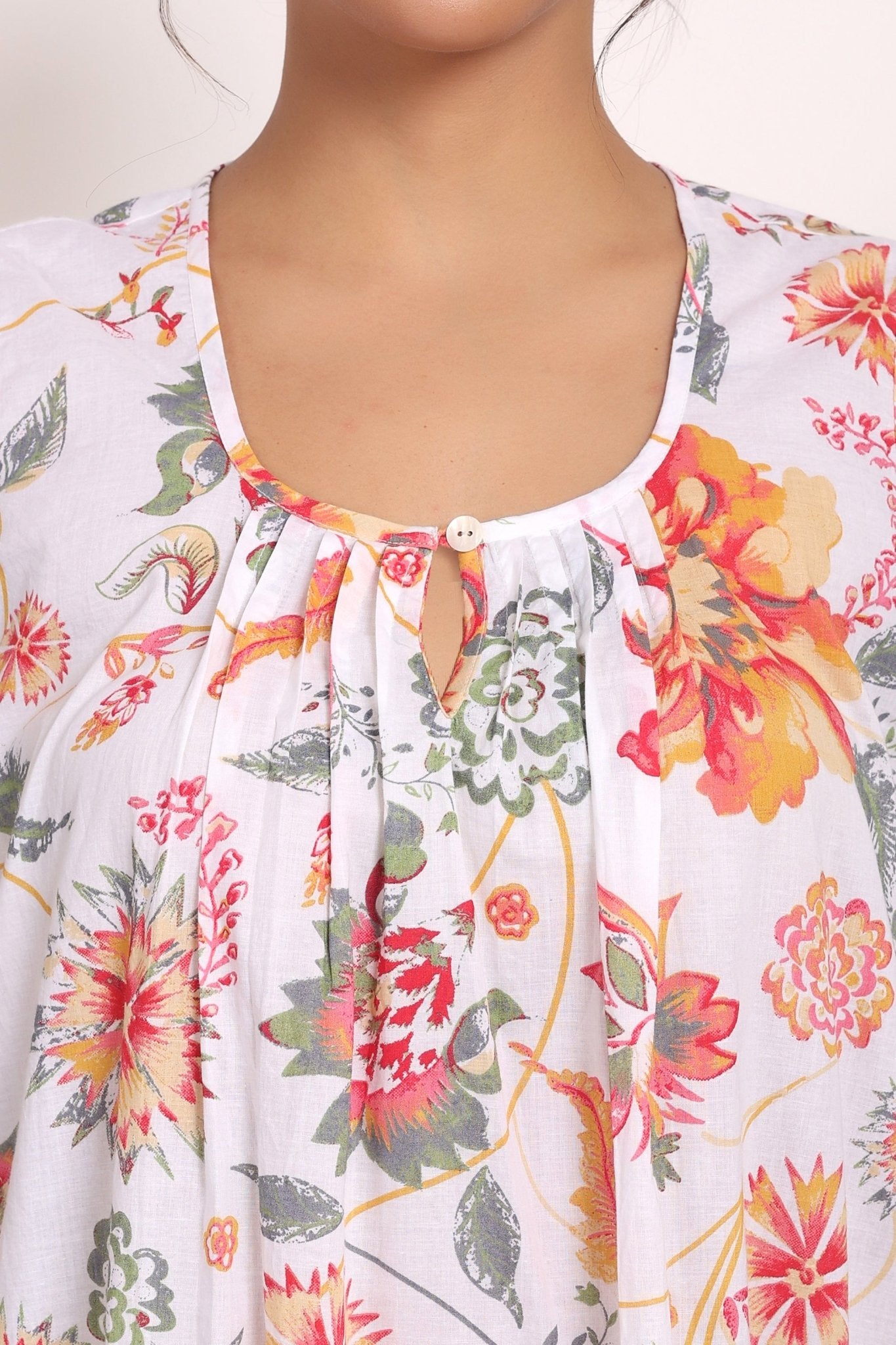 Detailed view of the softly gathered neckline with single button front.
