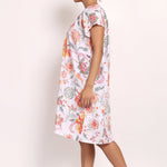 Side view of model walking in loose-fitting floral nightie, perfect for summer comfort.