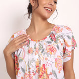 Smiling model in Passionflower nightie showing upper fit and light fabric texture.