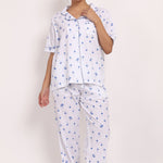 Model wearing Hamptons Shortsleeve Long PJ in lightweight cotton with navy palm print and contrast piping.