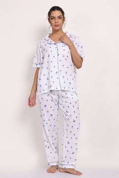 Model wearing Hamptons Shortsleeve Long PJ in lightweight cotton with navy palm print and contrast piping.