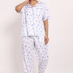 Front view of Hamptons cotton PJ set with short-sleeve top, piped detailing, and long pants in navy palm print.