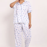 Front view of Hamptons cotton PJ set with short-sleeve top, piped detailing, and long pants in navy palm print.