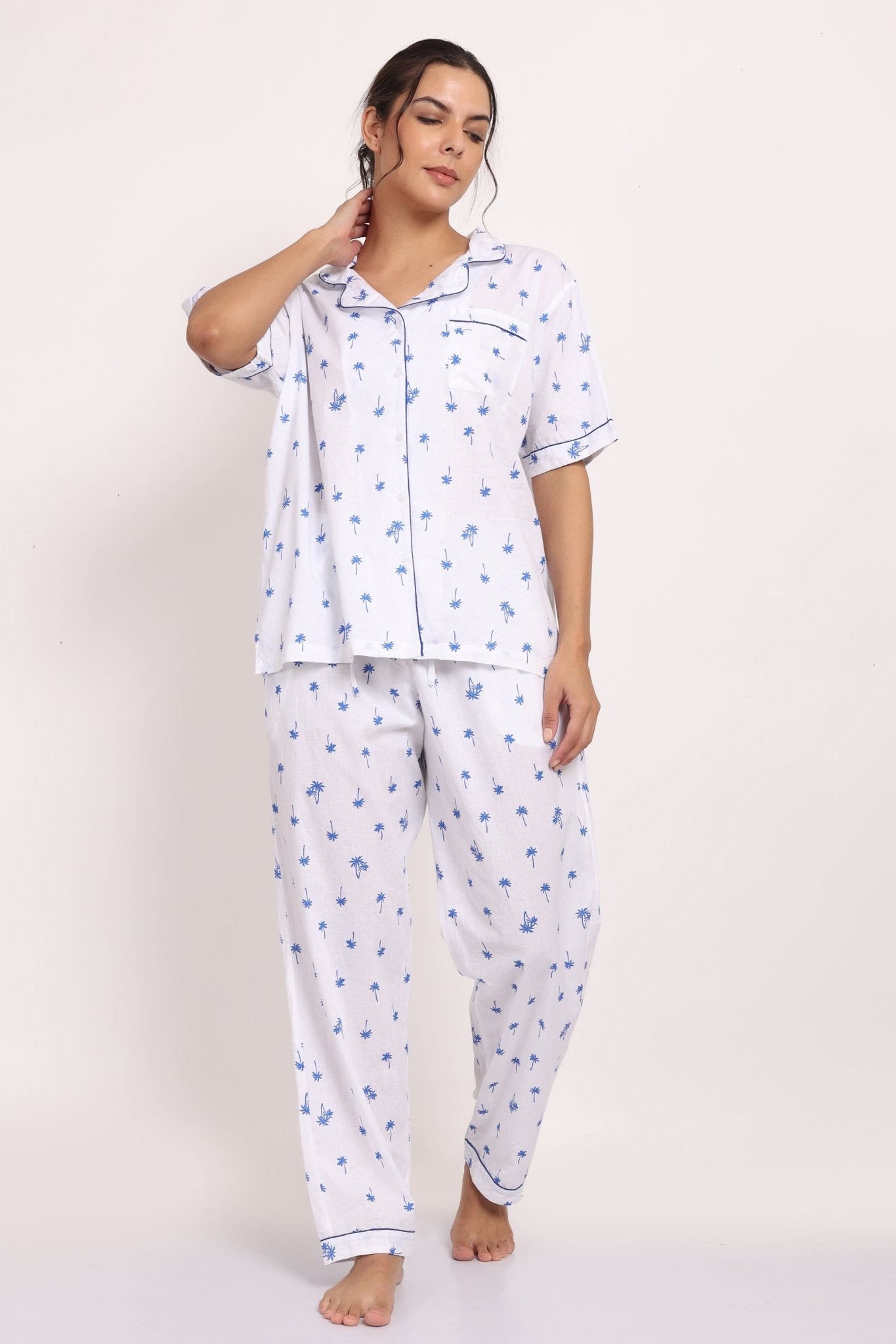 Front view of Hamptons cotton PJ set with short-sleeve top, piped detailing, and long pants in navy palm print.