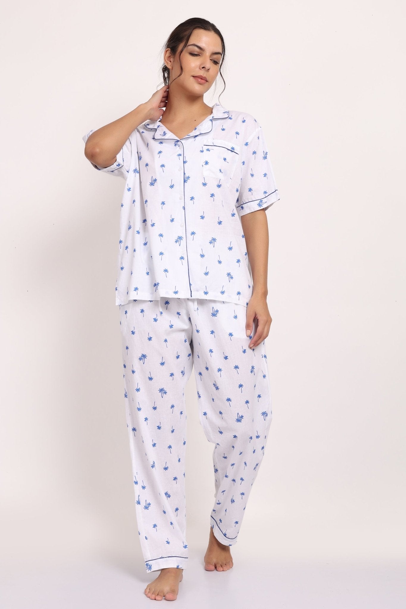 Front view of Hamptons cotton PJ set with short-sleeve top, piped detailing, and long pants in navy palm print.