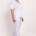 Side walking pose showing the relaxed fit and light drape of the Hamptons cotton pyjama set.