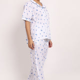 Side walking pose showing the relaxed fit and light drape of the Hamptons cotton pyjama set.