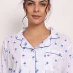 Close-up of piped collar, navy palm print, and button-up cotton PJ shirt in Hamptons set.