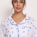 Close-up of piped collar, navy palm print, and button-up cotton PJ shirt in Hamptons set.