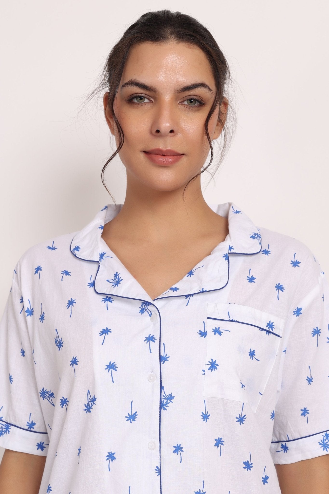 Close-up of piped collar, navy palm print, and button-up cotton PJ shirt in Hamptons set.