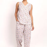 Model wearing Gatsby V-neck sleeveless cotton pyjama set in sage pink floral, front view.