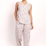Model wearing Gatsby V-neck sleeveless cotton pyjama set in sage pink floral, front view.