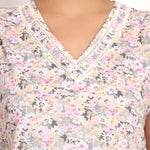 Close-up of vee neckline with ladder lace trim on Gatsby sleeveless cotton top.