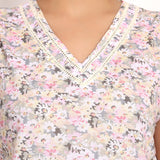 Close-up of vee neckline with ladder lace trim on Gatsby sleeveless cotton top.