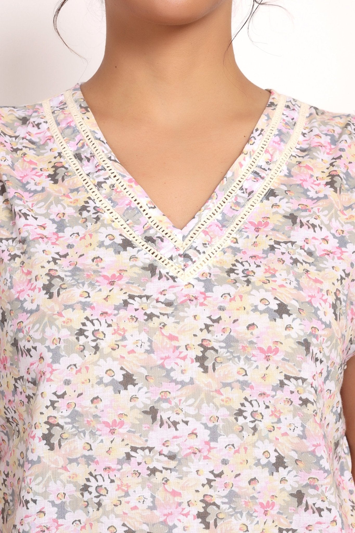 Close-up of vee neckline with ladder lace trim on Gatsby sleeveless cotton top.