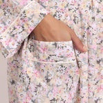 Close-up of pastel daisy floral cotton print with contrast trim on the Gatsby robe.