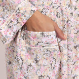 Close-up of pastel daisy floral cotton print with contrast trim on the Gatsby robe.