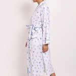 Side profile of model walking in the Hamptons navy palm print cotton robe.