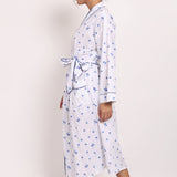 Side profile of model walking in the Hamptons navy palm print cotton robe.