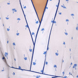 Zoomed view of white cotton voile with navy piping and micro palm print.