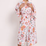 Model wearing Passionflower Kimono in coral print, featuring wide lapels, tie belt and relaxed cotton fit.